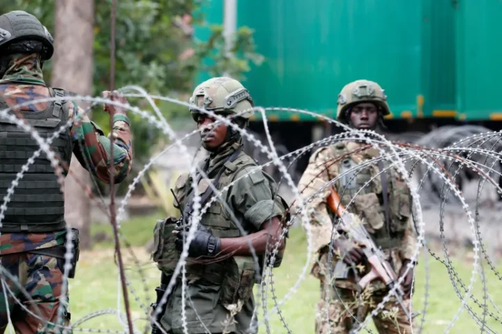 Soldiers from the M23 rebel group standing at the Grande Barrier border crossing point near Gisenyi, Rwanda, during clashes with the Armed Forces of the Democratic Republic of the Congo (FARDC) on January 29, 2025, amid the ongoing conflict in Goma.