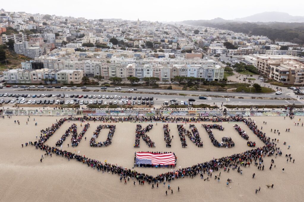 People form a human banner at Ocean Beach during the “No Kings” protests in San Francisco on Saturday, June 14, 2025. (Santiago Mejia/San Francisco Chronicle)